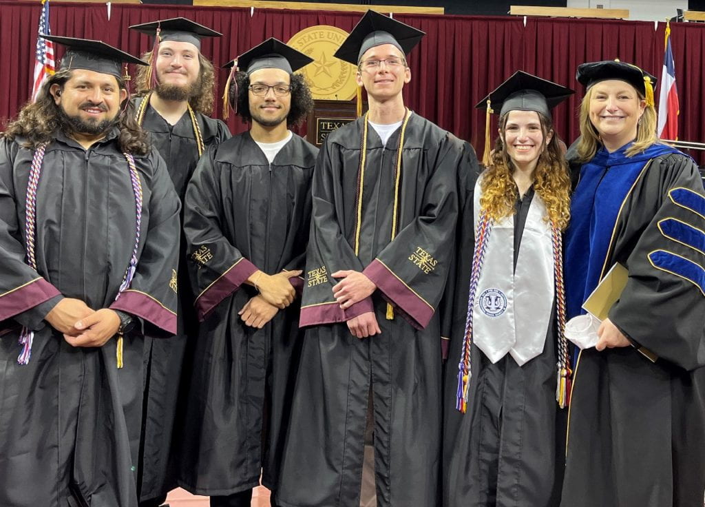 A group of people in graduation regalia