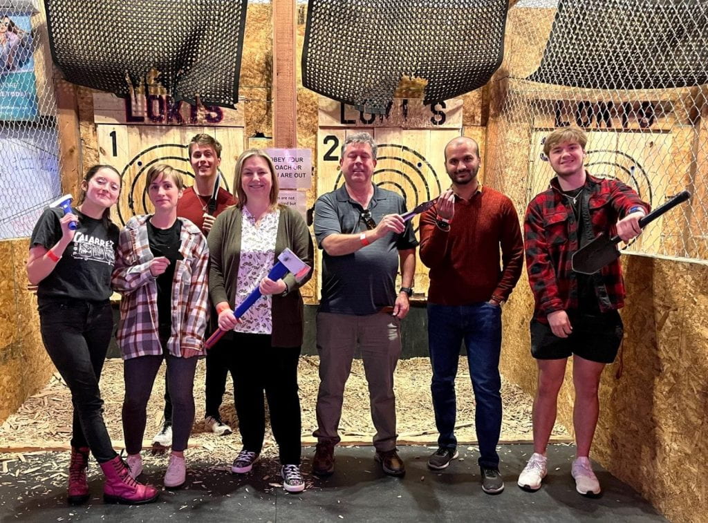 A group of people holding axes in front of targets